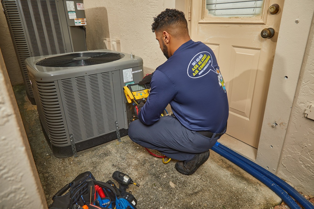 AC maintenance Delray Beach FL technician servicing residential AC system