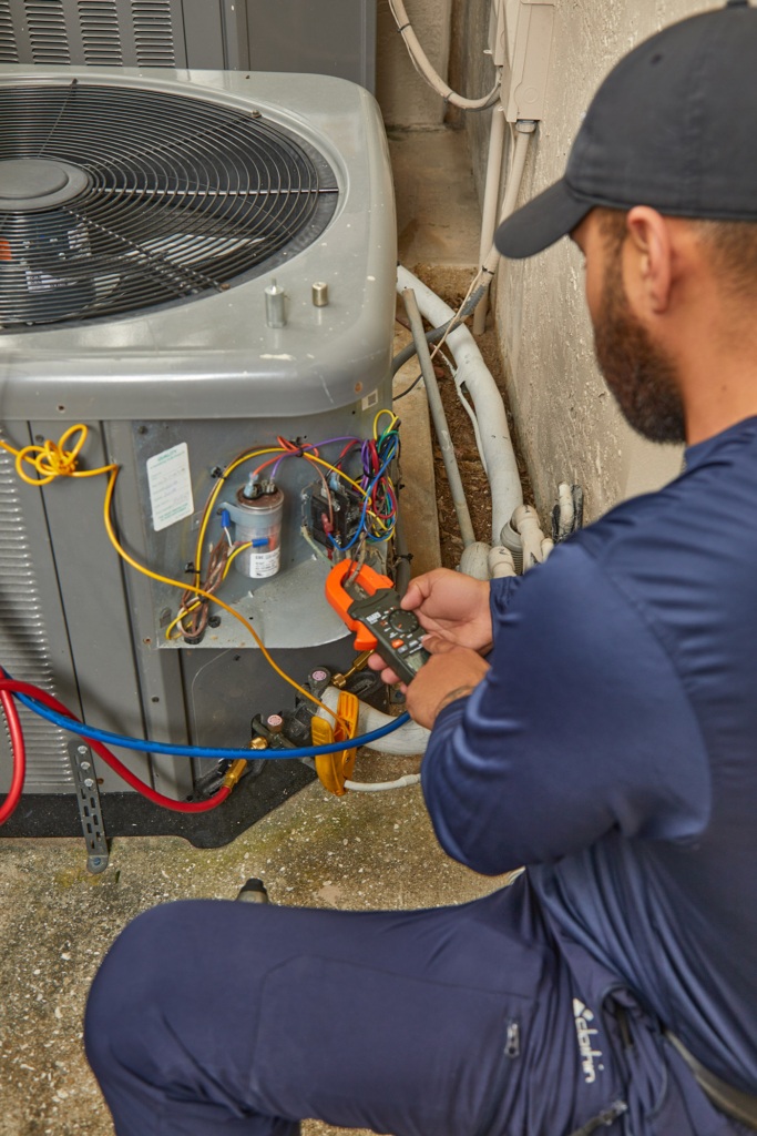 AC repair Delray Beach FL technician servicing outdoor air conditioning unit
