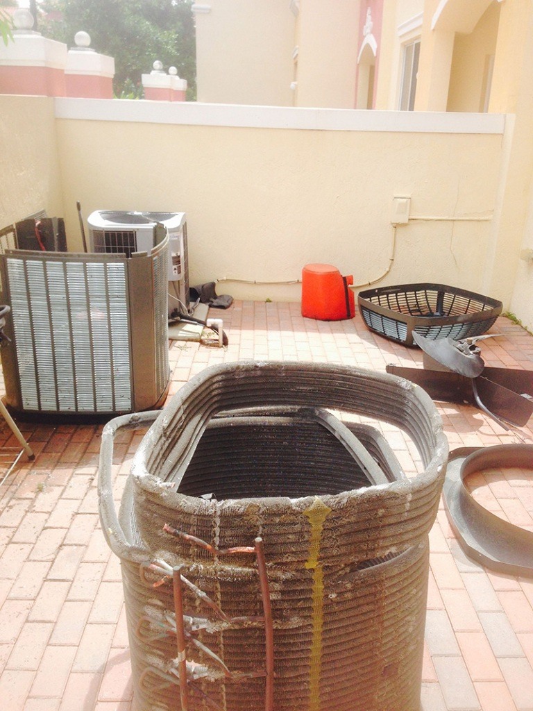 Heat pump repair Palm Beach County technician servicing residential heat pump system
