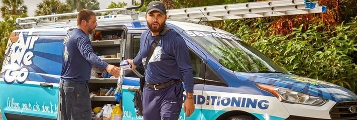 Heating service Palm Beach County technician servicing residential heat pump system